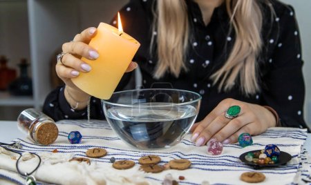 Foto de Woman fortune teller fortune telling wax candles. Selective focus. people. - Imagen libre de derechos