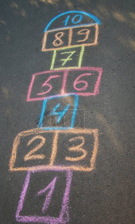 Photo for Backyard classics on an asphalt floor with chalk drawn numbers and squares. Selective focus. nature - Royalty Free Image