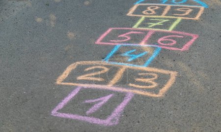 Photo for Backyard classics on an asphalt floor with chalk drawn numbers and squares. Selective focus. nature - Royalty Free Image