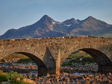 Photo for Famous old and ancient stone bridge of sligachan in the cuillin hills on the isle of skye in Scotland. - Royalty Free Image