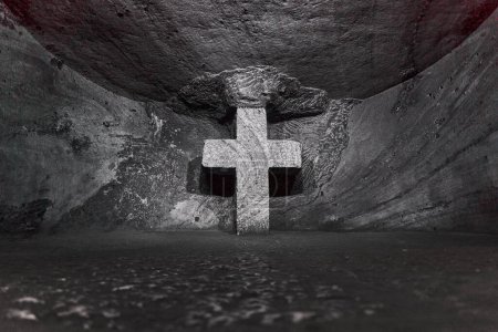 Photo for Zipaquira, Colombia - 04 12 2019: stone cross at catholic cathedral of Zipaquira is built into the tunnels of an underground salt mine and artfully illuminated in colorful light. - Royalty Free Image