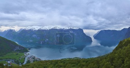 Téléchargez les photos : Paysage magnifique et tranquille de l'Aurlandsfjord près de Flam, vu du point de vue Stegastein haut au-dessus avec des sommets enneigés en arrière-plan. - en image libre de droit