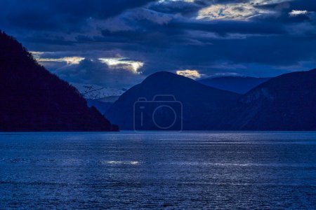 Photo for Sunset at the beautiful Sognefjord in Norway, with water ripples and dramatic sky. - Royalty Free Image