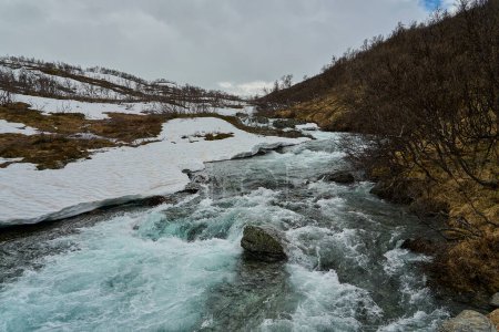 wild white water rapids of a lively river in the highlands of the Aurlandsvegen across the spectacular landscape in the mountains of Norway.