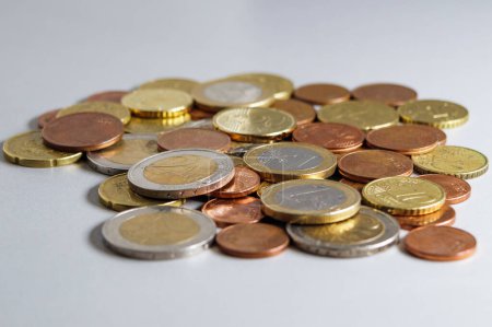 Foto de Spilled euro coins on a gray table. Soft focus. - Imagen libre de derechos