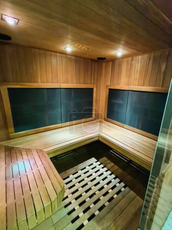 Photo for Inside view of the small sauna room in a spa. It is a small enclosed space for people to experience dry heat sessions. - Royalty Free Image