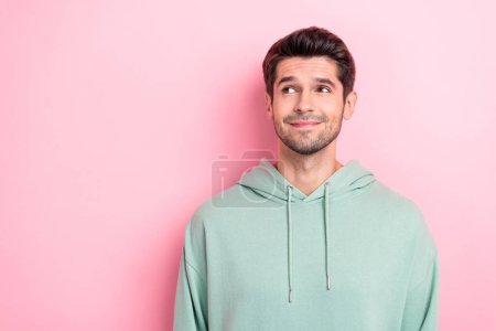 Portrait photo of cute positive nice guy looking shy empty space minded idea how date new girlfriend invite isolated on bright pink color background.