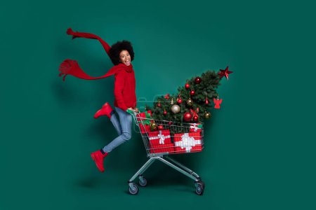 Photo of sweet impressed little school girl dressed red sweater scarf present shopping store mall isolated green color background.