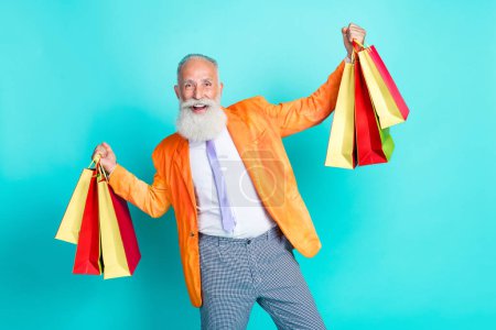 Photo of excited funky granddad hands hold shop bags rejoice isolated on turquoise color background.