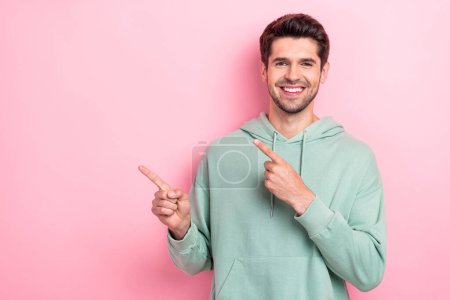 Photo of successful young student businessman just open his startup recommend investing project fingers point empty space isolated on pink color background.