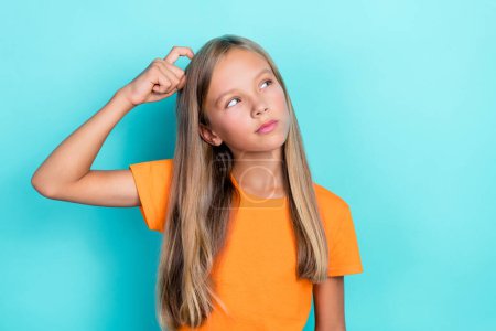 Closeup photo of youngster preteen girl kid thinking how solve problems looking interested empty space unsure scratch head isolated on cyan color background.