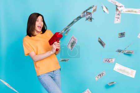 Photo of joyful cheerful lady look empty space win lottery celebrate rejoice waste money luxury life isolated on blue color background.
