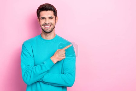 Photo portrait of handsome young man point empty space shopping banner dressed stylish blue outfit isolated on pink color background.