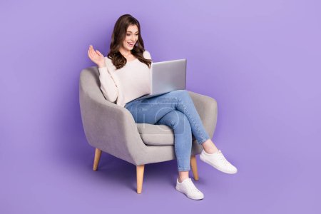 Photo of overjoyed lady hold netbook video call telegram twitter instagram messenger empty space isolated on purple color background.