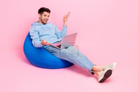Photo of positive successful worker influencer blogger use modern macbook speaking followers empty space isolated on pink color background.