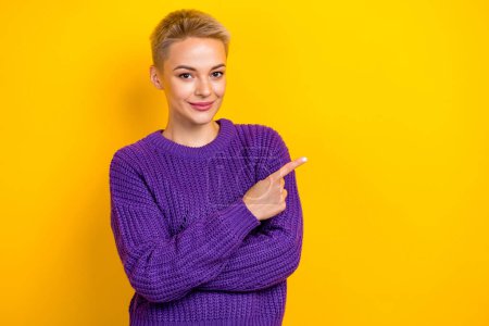 Photo of confident expert engineer blonde hair lady violet sweater finger indicate empty space new technology isolated on yellow color background.