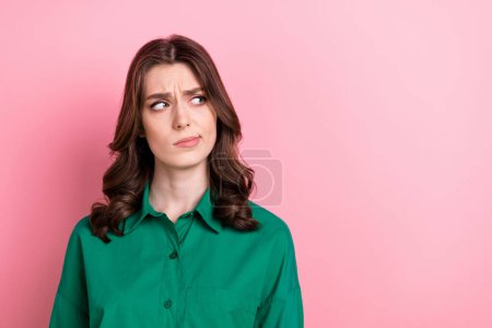 Portrait of minded pensive agent lady look interested empty space hesitate isolated on pink color background.