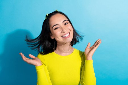 Photo of satisfied adorable person beaming smile arms clapping isolated on blue color background.
