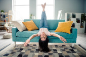 Photo of single lady toothy smiling laughing feel carefree fooling upside down in modern interior living room. Poster #657396108