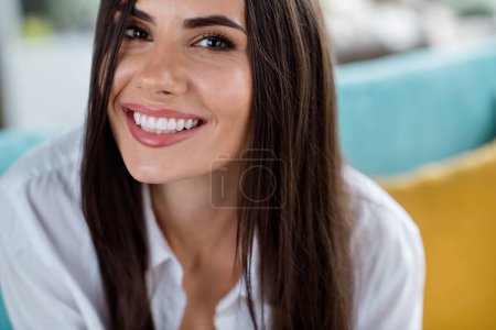Close up cropped portrait of cheerful peaceful stunning girl beaming smile good mood enjoy pastime apartment inside.