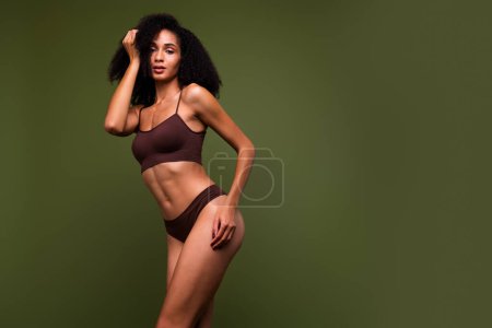 No filter studio photo of adorable cute woman wear lingerie loving her imperfect body empty space isolated khaki color background.