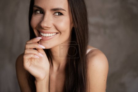 Close up photo no retouch of lovely adorable girl touch fingers lips thinking beauty advert isolated concrete grey color wall background.