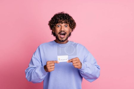 Photo of excited crazy man wear blue stylish clothes hold bank open mouth wow nfc cashless transactions isolated on pink color background.