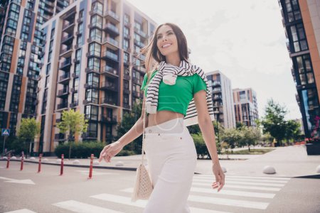 Portrait of attractive charming smiling young woman walking streets on modern urban city background concept success business lady outdoors.