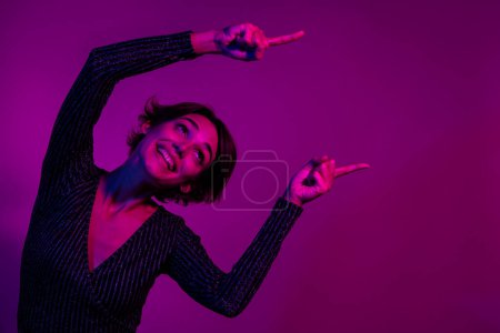 Photo portrait of lovely young lady point look empty space dressed stylish overall garment isolated on neon light pink color background.