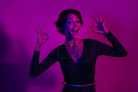 Photo portrait of pretty young girl show excited double okey dressed stylish overall outfit isolated on neon light pink color background.