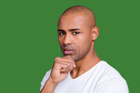 Close up photo not sure dark skin he him his man good-looking groomed shaved face hand arm on chin contemplation overthinking wearing white t-shirt outfit clothes isolated on grey background.