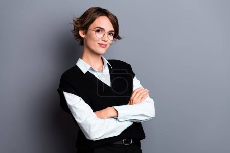 Photo of happy confident lady recruiter dressed black vest arms crossed empty space isolated grey color background.