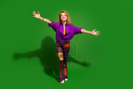 Photo portrait of lovely young lady stretching hands hugging dressed stylish violet clothes isolated on green color background.