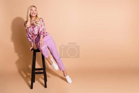 Full body portrait of pretty lady look empty space imagine wear shirt isolated on beige color background.