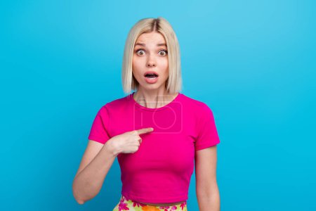 Photo portrait of lovely young lady point self shocked frightened dressed stylish pink clothes isolated on blue color background.