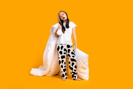 Full length photo of tired adorable nice woman wear trendy pajama late night isolated on yellow color background.
