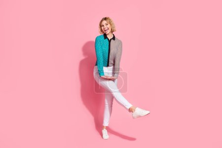Full size photo of pretty young girl dancing have fun enjoy disco wear trendy striped cyan outfit isolated on pink color background.