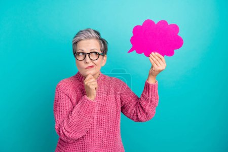 Portrait of pensive puzzled person wear knit pullover in eyewear look at mind cloud arm on chin isolated on turquoise color background.