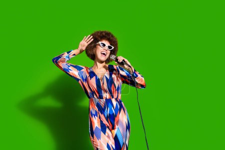 Photo of funny cute cheerful woman wear stylish clothes have fun friday enjoy weekend chill isolated on green color background.