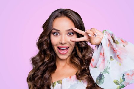 Close up portrait of attractive, pretty, dreamy, charming person make big smile and v-sign near eye look at camera isolated on vivid teal background.