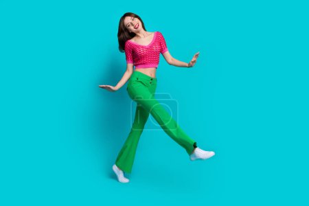 Full length photo of funny girlish woman dressed knitwear top green pants dancing celebrate black friday isolated on blue color background.