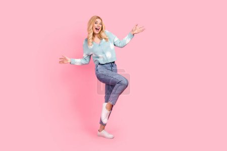Full size photo of lovely young woman dancing have fun dressed stylish flower print garment isolated on pink color background.
