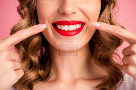 Cropped photo of lovely young woman lick teeth stomatology dressed stylish white garment hairdo isolated on pink color background.
