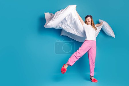 Photo of pretty lovely cute girl wear white stylish pajama relax rest have fun isolated on blue color background.