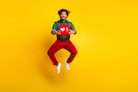 Full size photo of attractive elegant young man jump like logo wear shirt isolated on yellow color background.