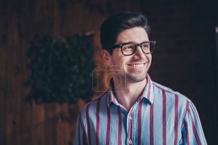 Photo of nice young man think inspiration wear striped shirt loft interior business center indoors.