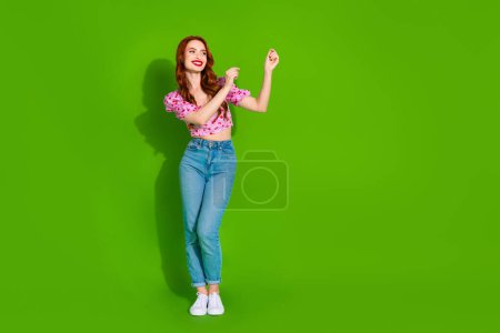 Full length photo of adorable lovely girl wear pink blouse having fun empty space isolated green color background.