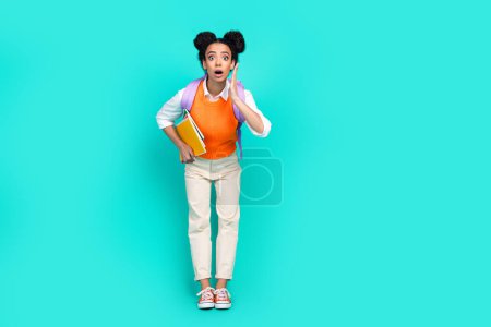 Full body portrait of nice young girl bag book empty space wear vest isolated on turquoise color background.