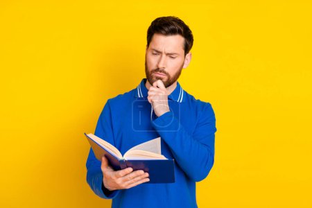Photo portrait of pretty young male read minded book wear trendy blue outfit isolated on yellow color background.