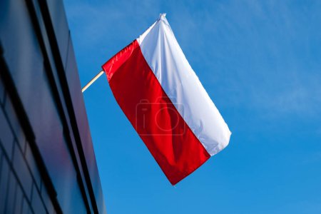Photo for Polish flag against a blue sky background - Royalty Free Image